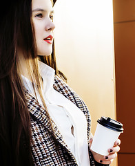 Image showing young pretty hipster girl student with coffee cup posing adorable smiling, lifestyle people concept outdoor 