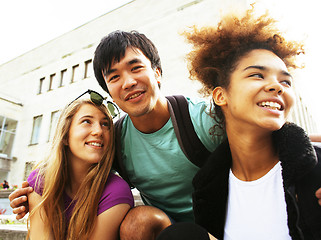 Image showing cute group of teenages at the building of university with books huggings, back to school