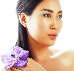 Image showing young pretty asian woman with flower purple orchid close up isolated spa, womans day concept