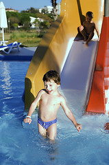 Image showing little cute real boy in swimming pool close up smiling, lifestyle vacation people concept