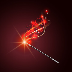 Image showing Magic wand with magical red sparkle trail