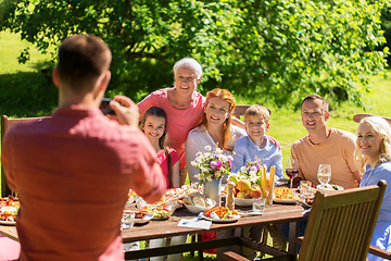 Image showing happy family photographing by smartphone in summer