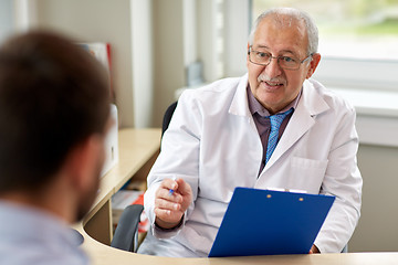 Image showing senior doctor talking to male patient at hospital