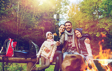 Image showing family with smartphone taking selfie near campfire