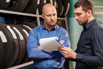 Image showing customer and salesman at car service or auto store