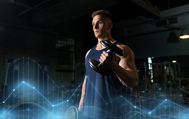 Image showing young man with dumbbells exercising in gym