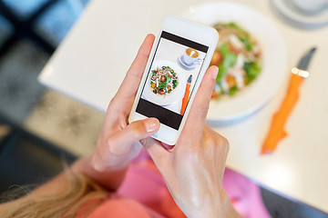 Image showing woman with smartphone photographing food at cafe