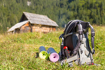 Image showing Backpack and yoga mats on mountain meadow.