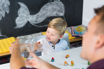 Image showing Cute little toddler boy at speechtherapist session.