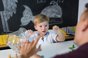 Image showing Cute little toddler boy at speechtherapist session.