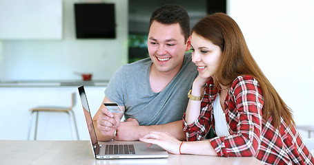 Image showing Couple Using Laptop To Shop Online in modern apartment