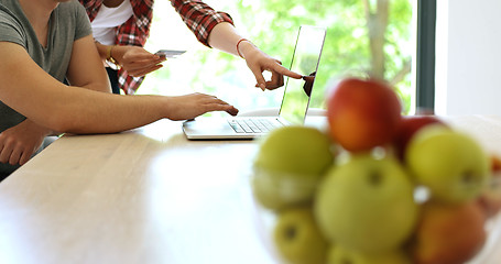 Image showing Couple Using Laptop To Shop Online in modern apartment