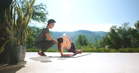 Image showing Couple Doing Stretching Exercises Together in front of luxury vi