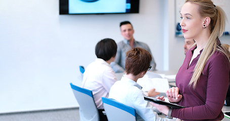 Image showing Pretty Businesswoman Using Tablet In Office Building during conf