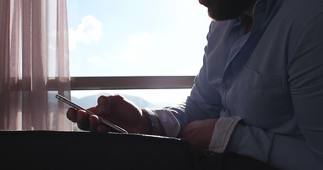 Image showing Business Man Talking On Cell Phone At Home