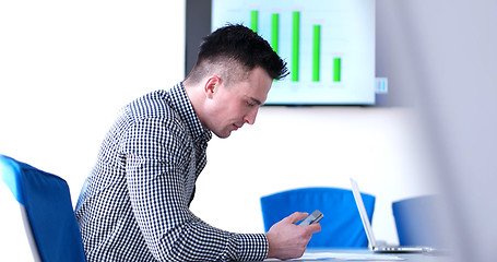 Image showing Senior businessman  using cell phone at  stratup office