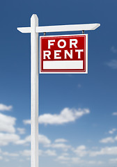 Image showing Right Facing For Rent Real Estate Sign on a Blue Sky with Clouds