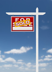 Image showing Left Facing Sold For Sale Real Estate Sign on a Blue Sky with Cl