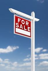 Image showing Left Facing For Sale Real Estate Sign on a Blue Sky with Clouds.