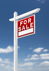 Image showing Right Facing For Sale Real Estate Sign on a Blue Sky with Clouds