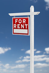 Image showing Left Facing For Rent Real Estate Sign on a Blue Sky with Clouds.