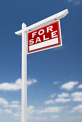 Image showing Right Facing For Sale Real Estate Sign on a Blue Sky with Clouds