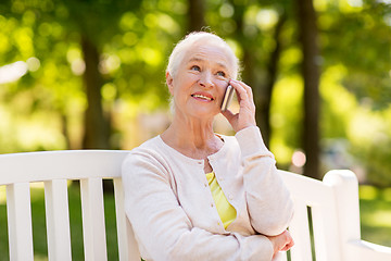 Image showing happy senior woman calling on smartphone in summer