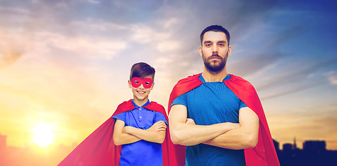 Image showing father and son in superhero capes over city