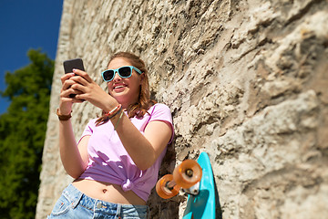 Image showing happy teenage girl with longboard and smartphone