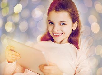 Image showing happy girl in bed with tablet pc over lights