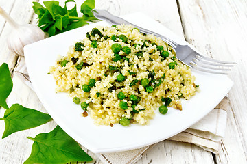 Image showing Couscous with spinach in plate on light board