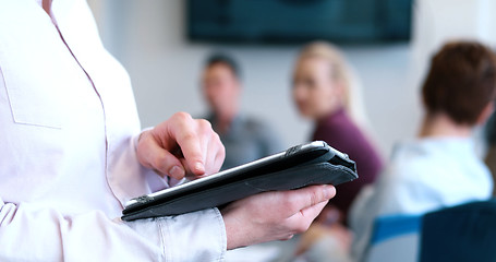 Image showing Portrait of  smiling casual businesswoman using tablet  with cow