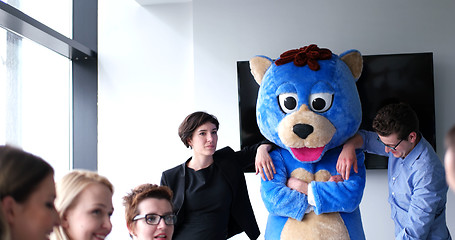 Image showing boss dresed as bear having fun with business people in trendy of