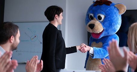 Image showing boss dresed as bear having fun with business people in trendy of