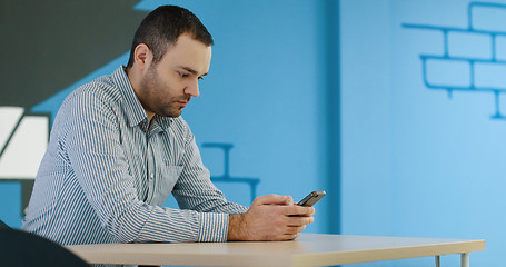 Image showing Senior businessman  using cell phone at  stratup office