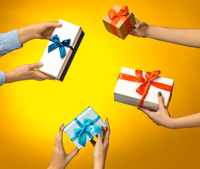 Image showing The closeup picture of man and woman\'s hands with gift box