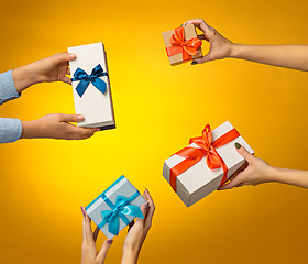 Image showing The closeup picture of man and woman\'s hands with gift box