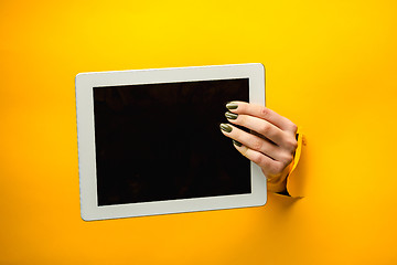 Image showing female teen hands using tablet pc with black screen, isolated