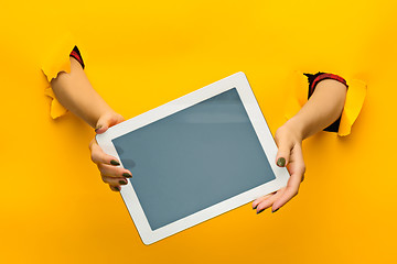 Image showing female teen hands using tablet pc with black screen, isolated