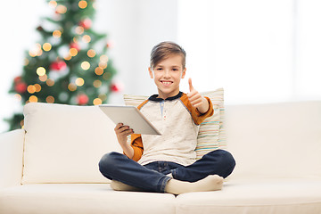 Image showing boy with tablet pc showing thumbs up at christmas