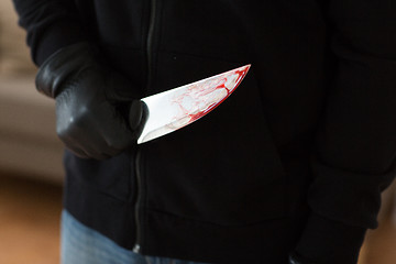 Image showing close up of criminal with blood on knife