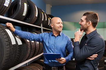 Image showing customer and salesman at car service or auto store