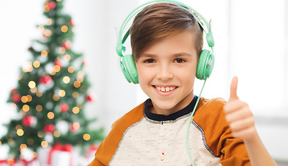 Image showing boy in headphones showing thumbs up at christmas