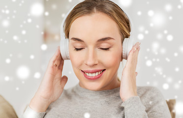 Image showing woman with headphones listening to music at home