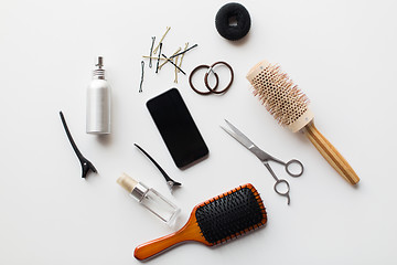 Image showing smartphone, scissors, brushes and other hair tools