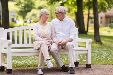 Image showing happy senior couple sitting on bench at park