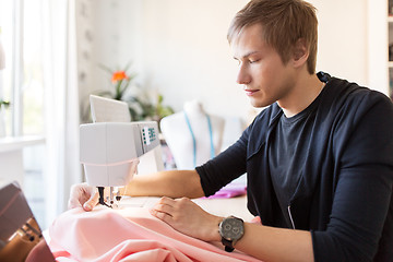 Image showing fashion designer with sewing machine working