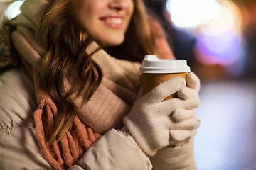 Image showing happy woman with coffee over christmas lights