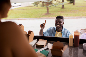 Image showing african american man ordering wok at food truck