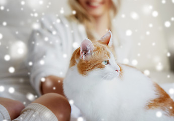 Image showing happy young woman with cat in bed at home